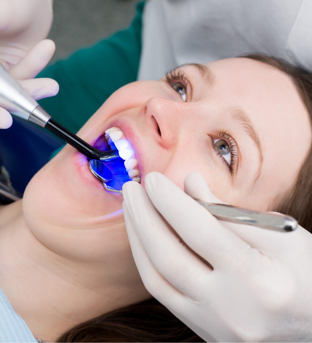 dentist-working-with-dental-polymerization-lamp